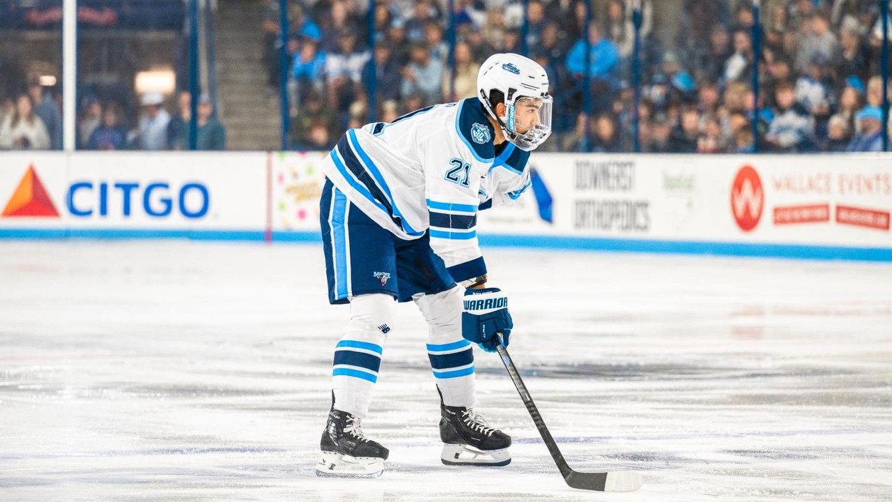 Isa Parekh on the ice in a Maine uniform.