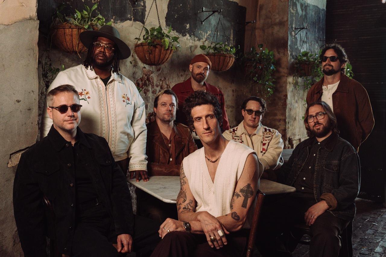 Members of The Revivalists pose for a press photograph.